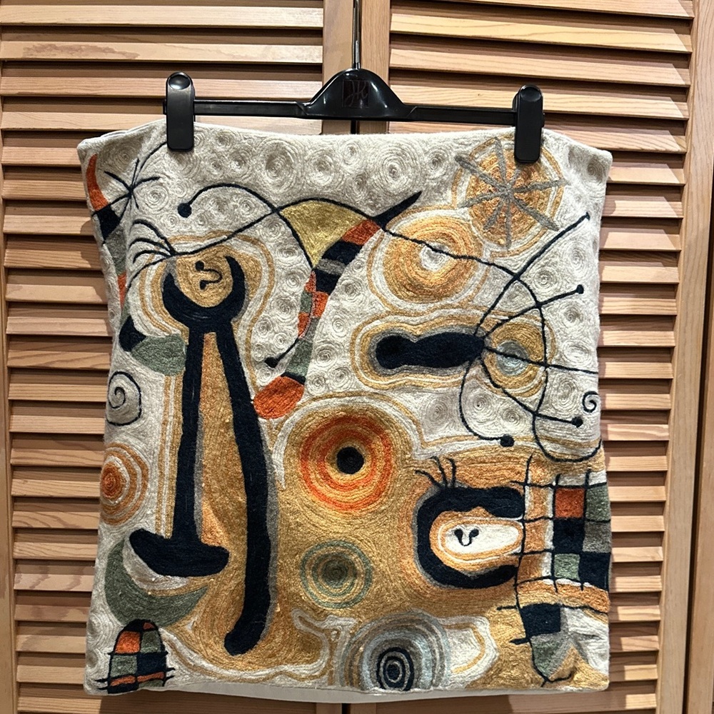 Handwoven artisan embroidered square accent pillowcase in the style of Miró